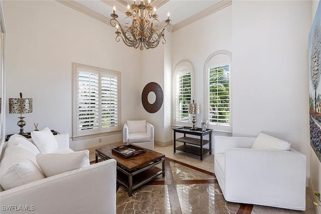 sitting room featuring crown molding and an inviting chandelier