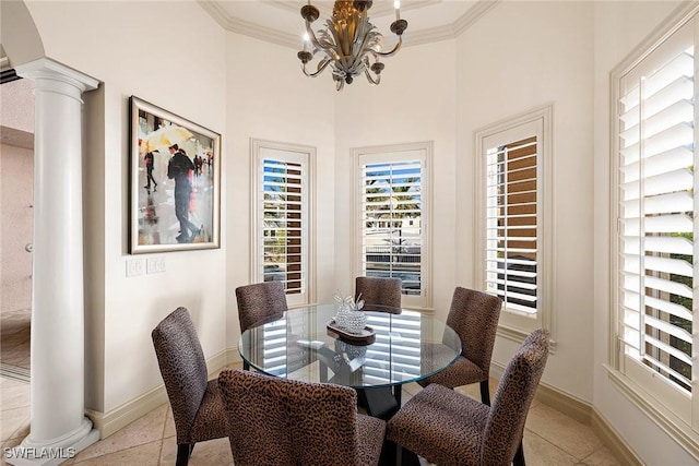 tiled dining area featuring ornate columns, crown molding, and a chandelier