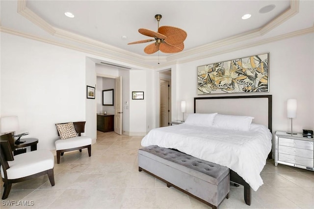 bedroom with a raised ceiling, ensuite bath, and ceiling fan