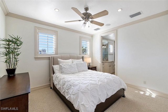 bedroom featuring ceiling fan, light colored carpet, crown molding, and ensuite bath