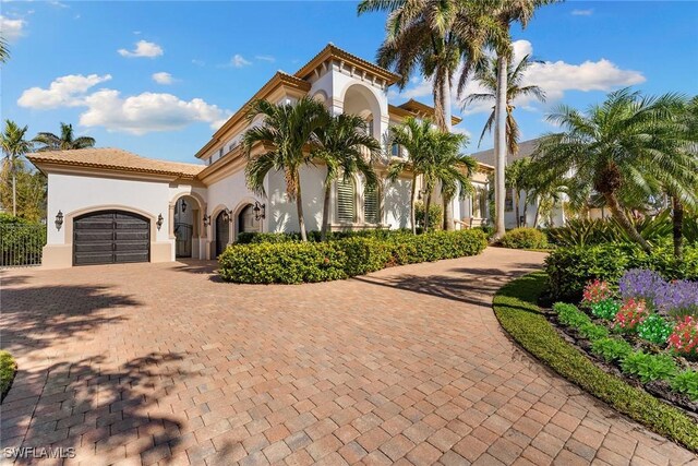 mediterranean / spanish home featuring a garage