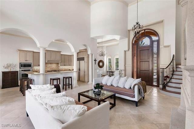 living room with a towering ceiling and an inviting chandelier