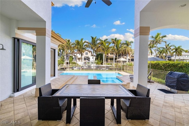 view of patio featuring a fenced in pool and grilling area