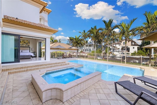 view of pool with an in ground hot tub and a patio area