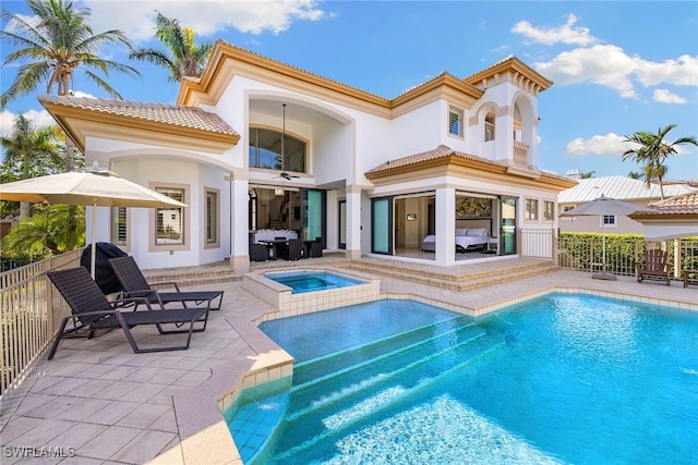 rear view of property featuring a patio area and a pool with hot tub