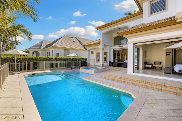 view of swimming pool featuring an in ground hot tub, a patio, and ceiling fan