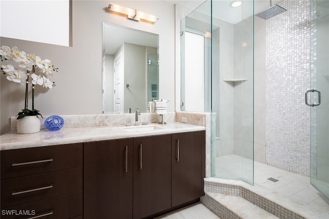 bathroom with vanity and a shower with shower door