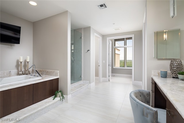 bathroom featuring plus walk in shower and vanity