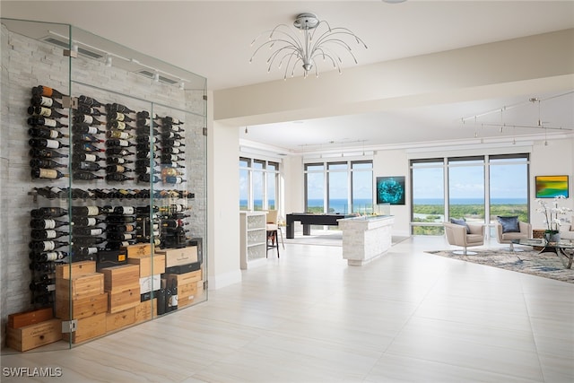 wine room with a notable chandelier and light tile patterned floors