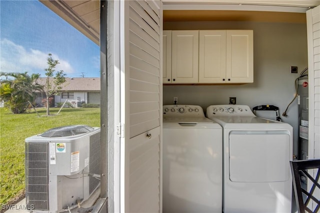 washroom featuring washing machine and clothes dryer and cabinets