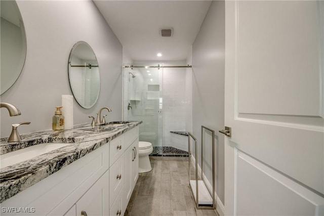 bathroom featuring vanity, toilet, and walk in shower