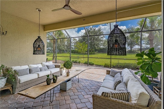 view of patio featuring ceiling fan, outdoor lounge area, and a lanai