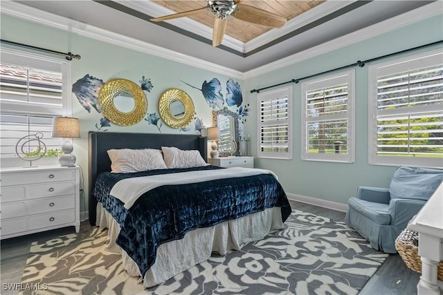 bedroom with wood-type flooring, wood ceiling, ornamental molding, ceiling fan, and a tray ceiling