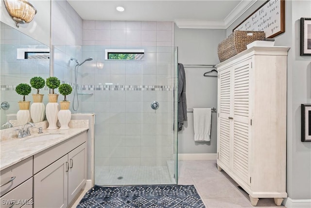 bathroom featuring tile patterned floors, tiled shower, vanity, and ornamental molding