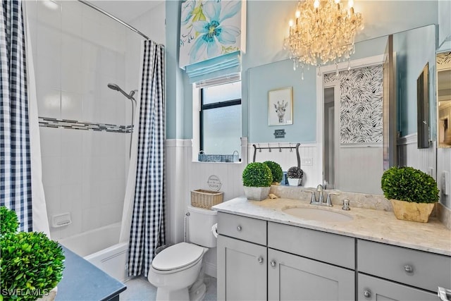 full bathroom with vanity, toilet, a chandelier, and shower / bath combo