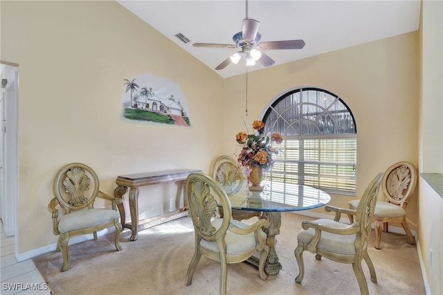 carpeted dining room with ceiling fan and lofted ceiling