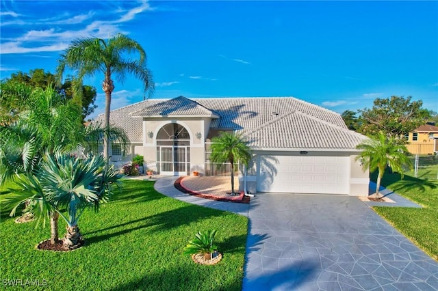 mediterranean / spanish-style home with a front lawn and a garage