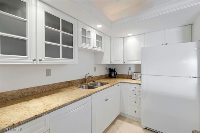 kitchen featuring white cabinets, light stone countertops, white appliances, and sink