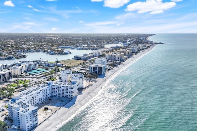 drone / aerial view featuring a beach view and a water view