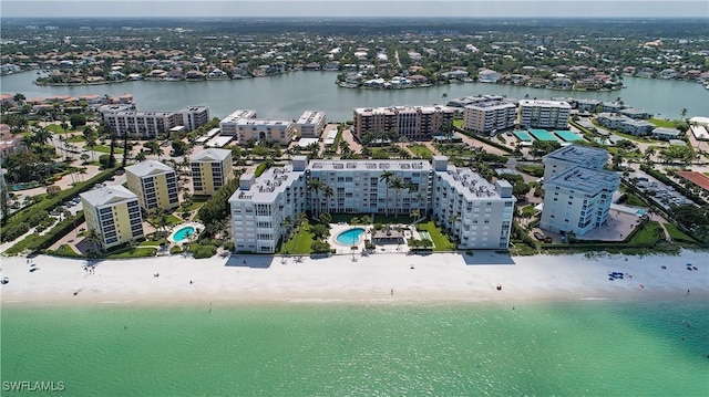 birds eye view of property with a beach view and a water view