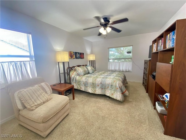 carpeted bedroom with multiple windows and ceiling fan