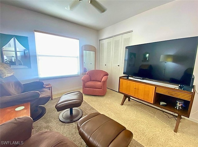 carpeted living room with ceiling fan