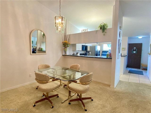 carpeted dining space with high vaulted ceiling and a notable chandelier