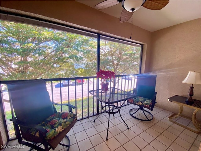 unfurnished sunroom featuring ceiling fan