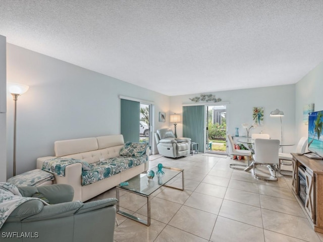 tiled living room featuring a textured ceiling