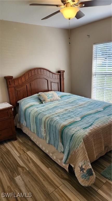 bedroom with hardwood / wood-style flooring and ceiling fan