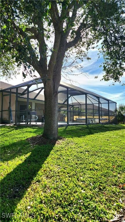 view of yard featuring glass enclosure