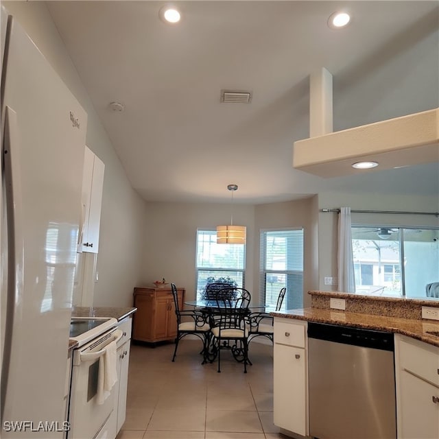 kitchen featuring pendant lighting, white appliances, dark stone counters, light tile patterned flooring, and white cabinetry