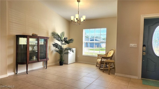 tiled entrance foyer with an inviting chandelier