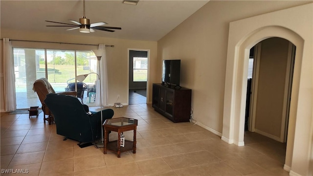 tiled living room with ceiling fan and lofted ceiling