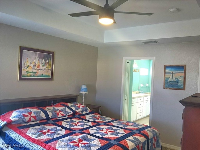 bedroom featuring ensuite bath and ceiling fan