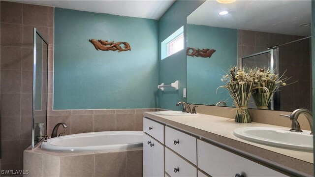 bathroom with shower with separate bathtub and vanity