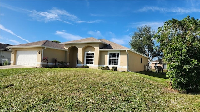 view of front of house featuring a garage and a front yard