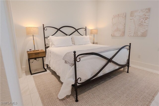 bedroom featuring light tile patterned flooring