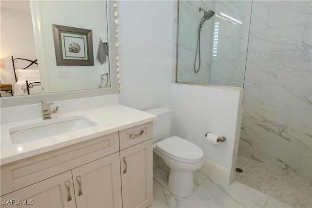 bathroom featuring toilet, vanity, and tiled shower