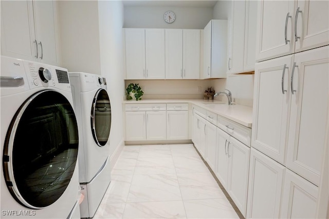 washroom featuring cabinet space, marble finish floor, a sink, and independent washer and dryer