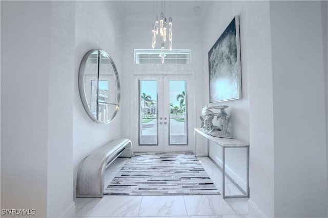 entryway featuring marble finish floor, baseboards, a notable chandelier, and french doors