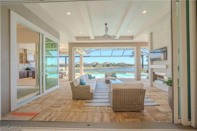 sunroom featuring beam ceiling and ceiling fan