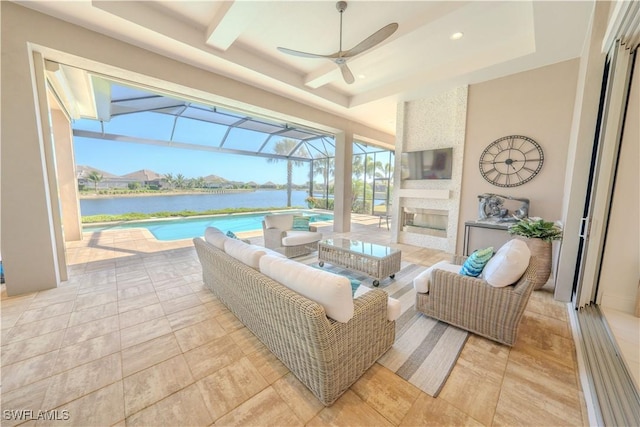 view of patio with an outdoor living space with a fireplace, a water view, and glass enclosure