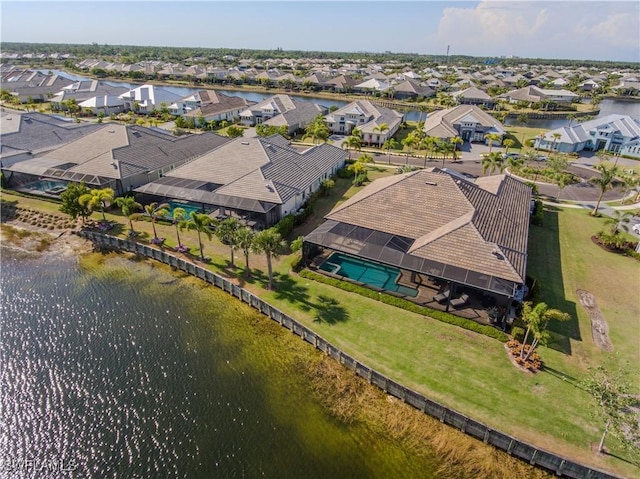 birds eye view of property featuring a water view and a residential view