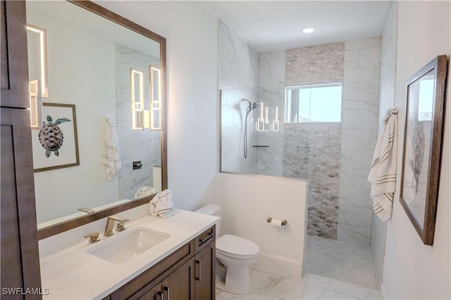 bathroom with toilet, marble finish floor, a marble finish shower, and vanity