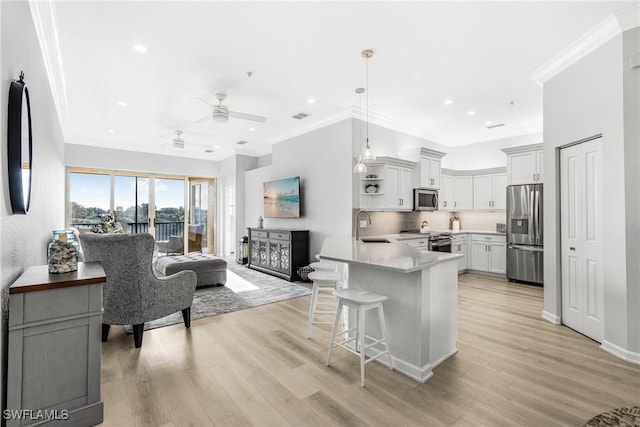 kitchen with white cabinetry, ceiling fan, stainless steel appliances, and light hardwood / wood-style floors