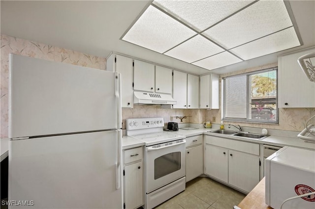 kitchen featuring white cabinetry, white appliances, sink, and light tile patterned floors