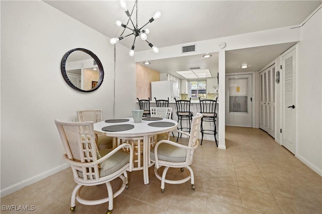 dining room featuring light tile patterned floors and a chandelier