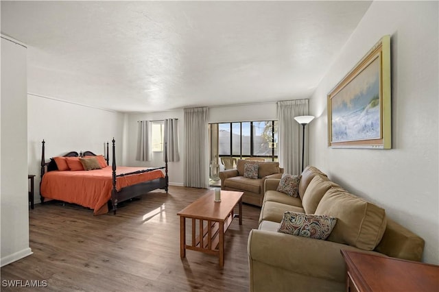 bedroom with dark wood-type flooring