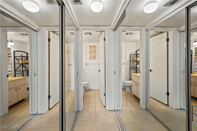 hall featuring light tile patterned flooring